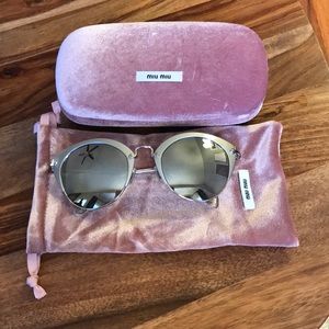 Miu Miu Mirror sunglasses.